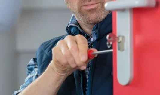 man repair a door lock