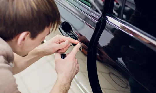 man tries to unstuck broken car key
