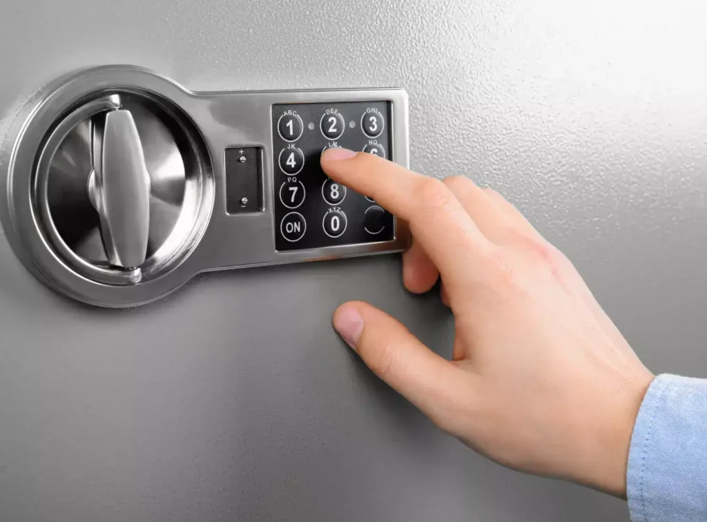 Person entering a code on a digital safe keypad lock