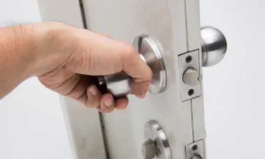 man open a door with a doorknob