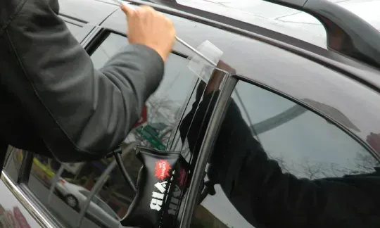 locksmith uses a slim jim tool
