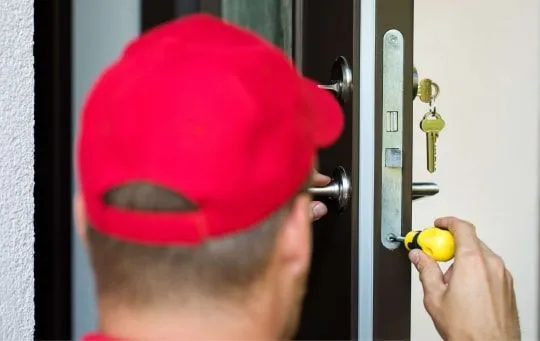 man repairing a door lock