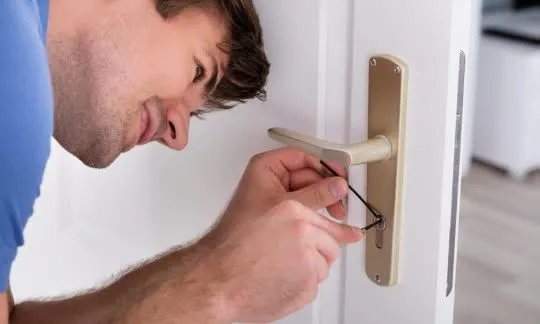 man tries to pick a lock