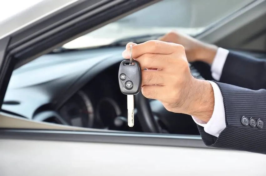 Hand holding a car key