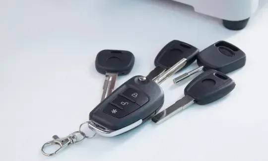 key fob and car keys on table