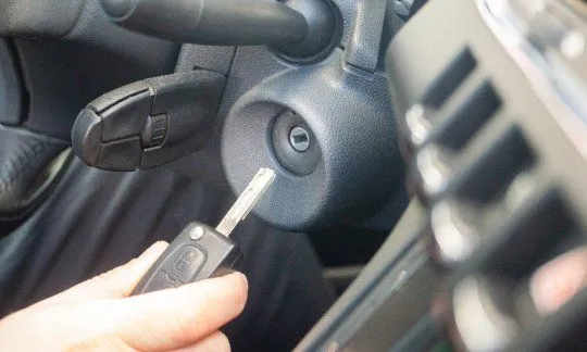 hands of a woman handing over a set of car keys to a second woman