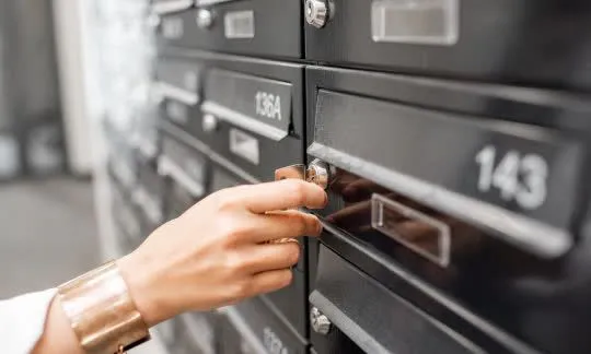 woman unlocks a mailbox