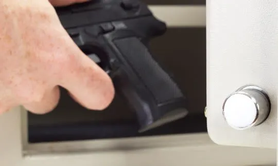 putting gun into a safe