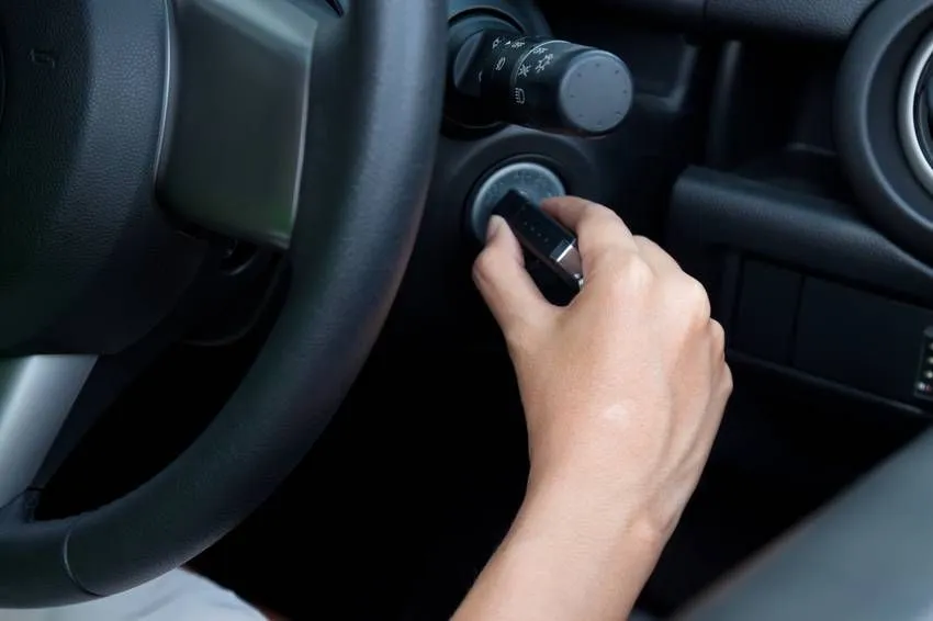 woman starting the car